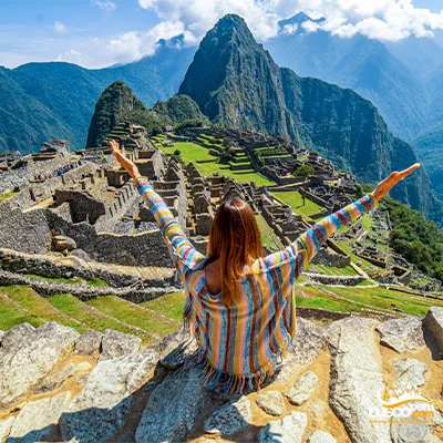 Girl opening her arms in Machu Picchu